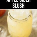 A close-up of a mason jar filled with light yellow Apple Cider Slush, with a black and white banner on top reading "Apple Cider Slush" and a red ribbon labeled "Tempting".