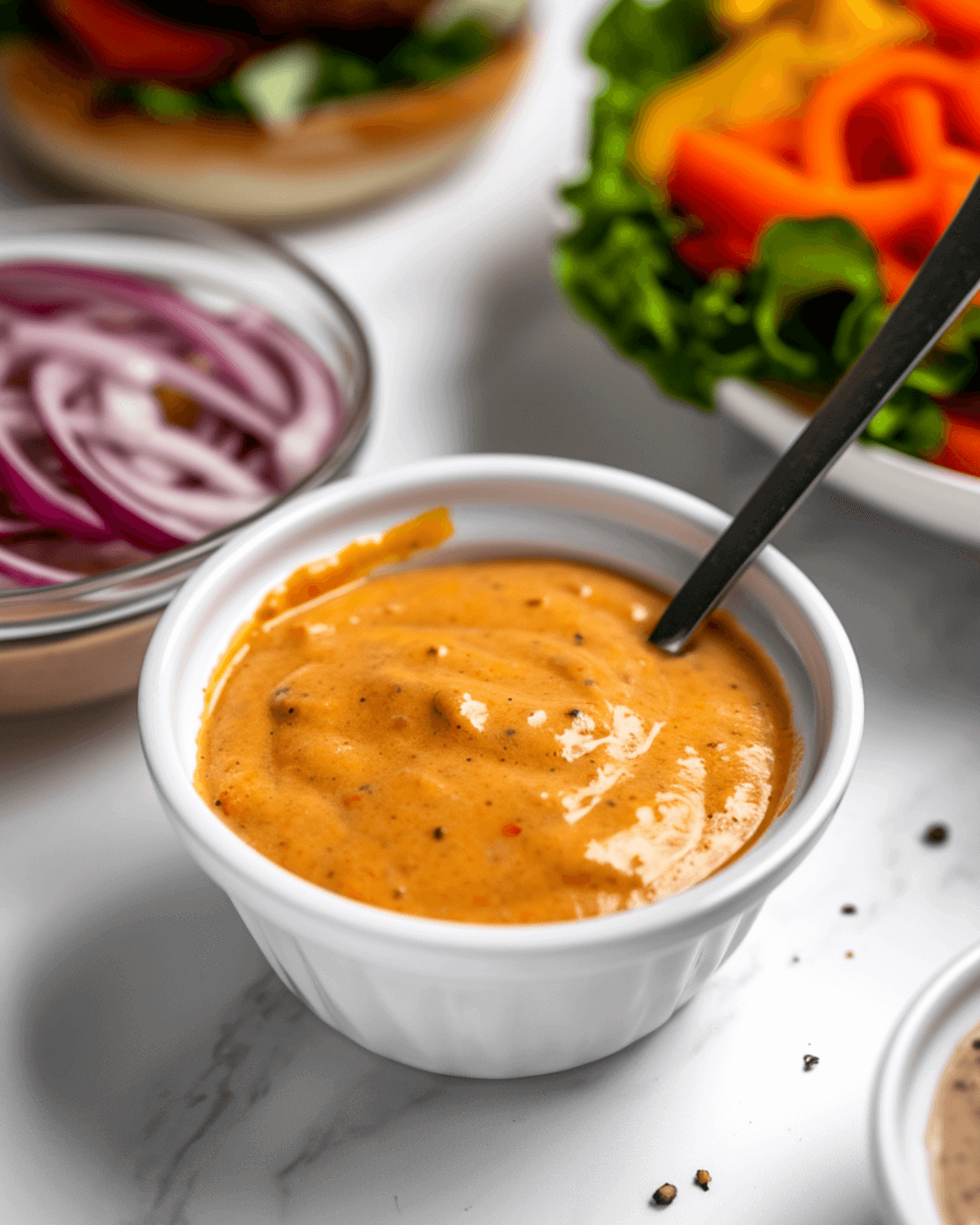 Burger sauce in a white bowl with spoon. 