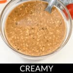 A bowl of creamy balsamic dressing with visible herbs, accompanied by a spoon. Text at the bottom of the image reads "Indulgent and Flavorsome: Creamy Balsamic Dressing.