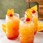 The refreshing cocktail garnished with fresh fruit.