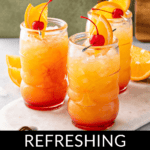 Three glasses of Jamaican rum punch, garnished with orange slices and cherries, are elegantly placed on a marble tray. Text at the bottom reads, "Refreshing Jamaican Rum Punch.