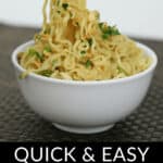 Chopsticks lift a generous portion of spicy peanut noodles from a white bowl. Text below reads, "QUICK & EASY SPICY PEANUT NOODLES.