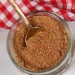 A jar of the best bbq spice rub on a checkered napkin.