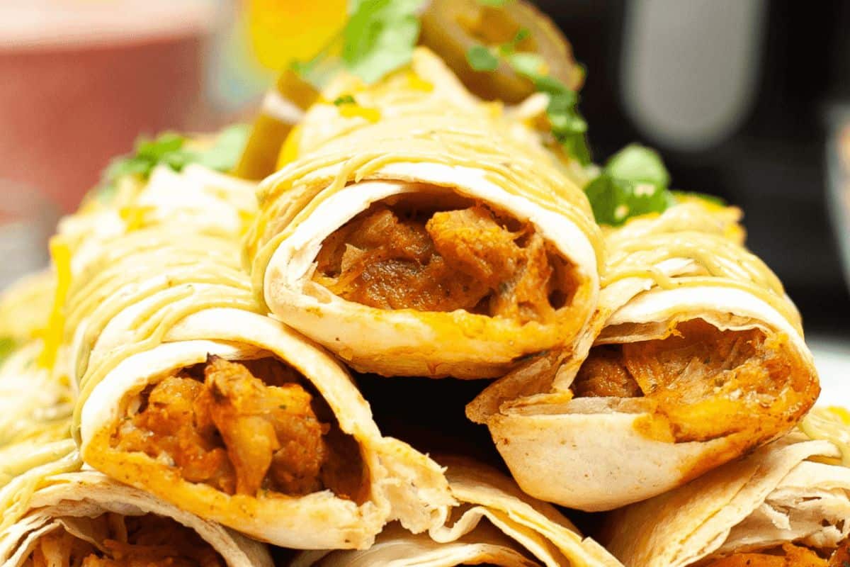 Chicken taquitos stacked on each other. 