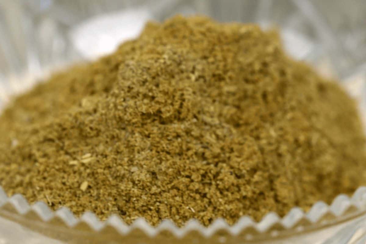 Bowl of green-colored substitute for poultry seasoning. 