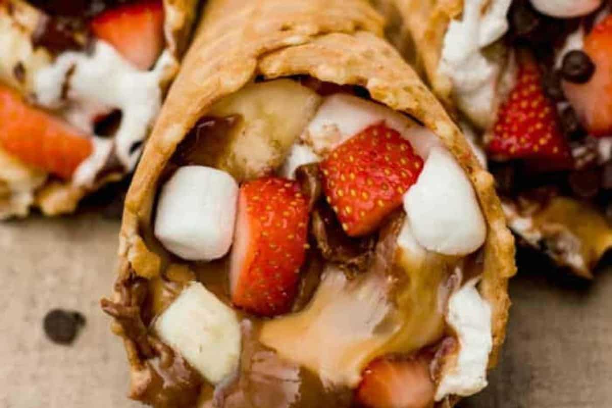 Campfire cone filled with strawberries, chocolate, and marshmallows. 