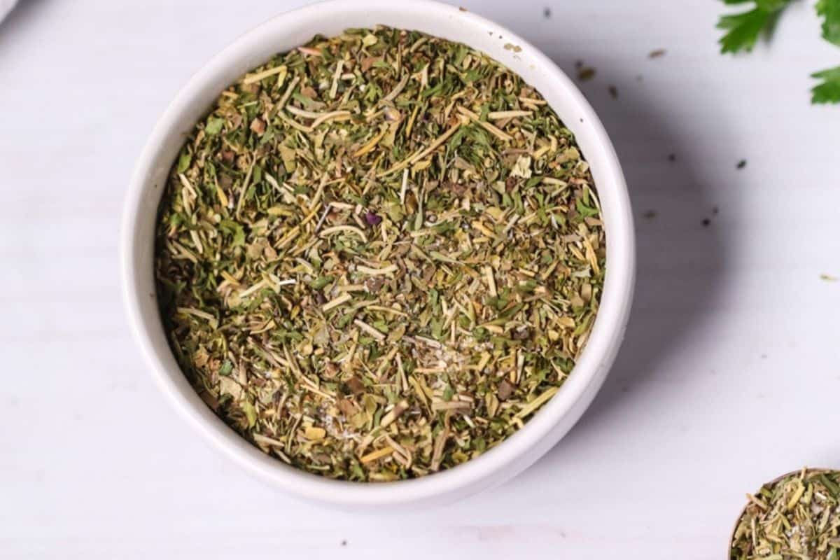 White bowl of garlic and herb seasoning.