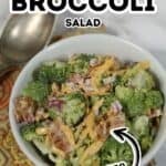 A bowl of Amish broccoli salad with crispy bacon, shredded cheese, and red onion sits on a patterned cloth. Text on the image reads "Amish Broccoli Salad, 15 Minutes.