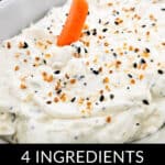 Close-up of everything bagel dip topped with a mini carrot and seasoning, placed inside a white dish. Text overlay reads: "4 Ingredients Everything Bagel Dip." Perfect for any gathering or snack time!