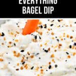         Close-up of a carrot stick being dipped into a creamy everything bagel dip topped with seeds and seasoning, with text above reading "4 Ingredients Everything Bagel Dip.