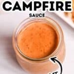 A small glass jar filled with creamy orange Red Robin Campfire Sauce sits on a light surface, with the words “Red Robin Campfire Sauce Copy Cat” overlaid.