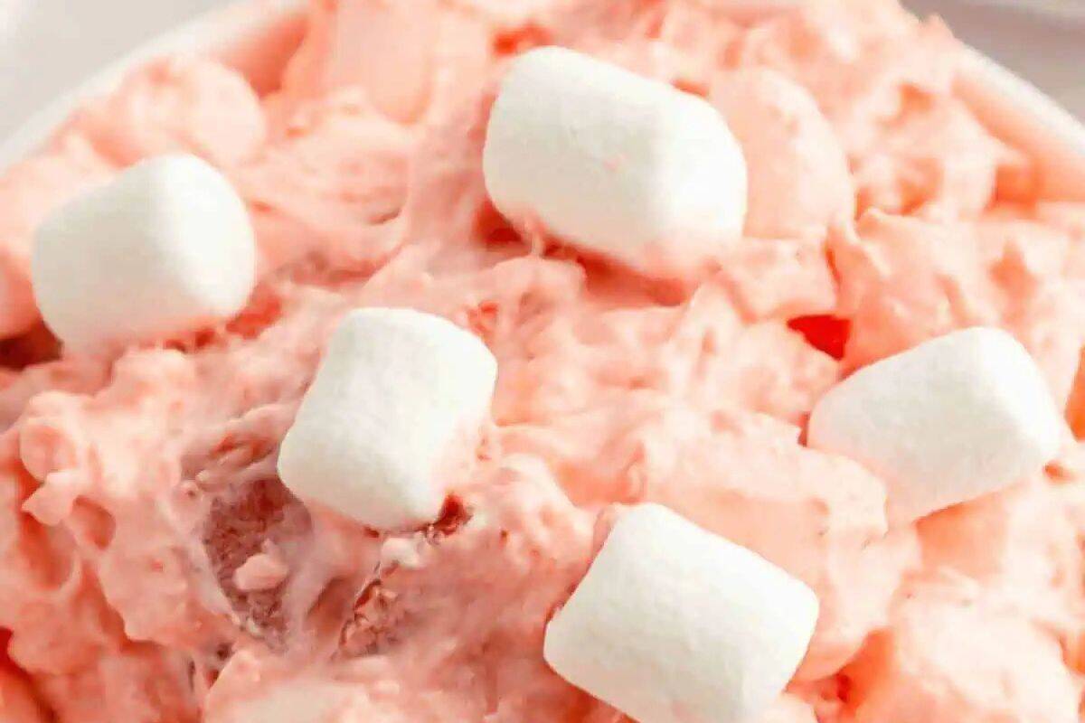 Close-up of a strawberry fluff salad. ganished with mini marshmallows.