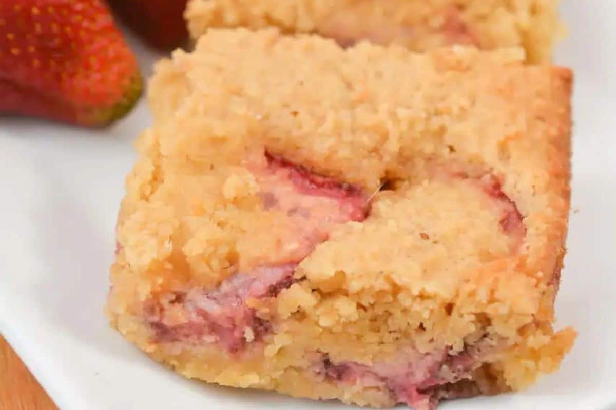 Close-up of a strawberry lemon blondie, served on a white plate.