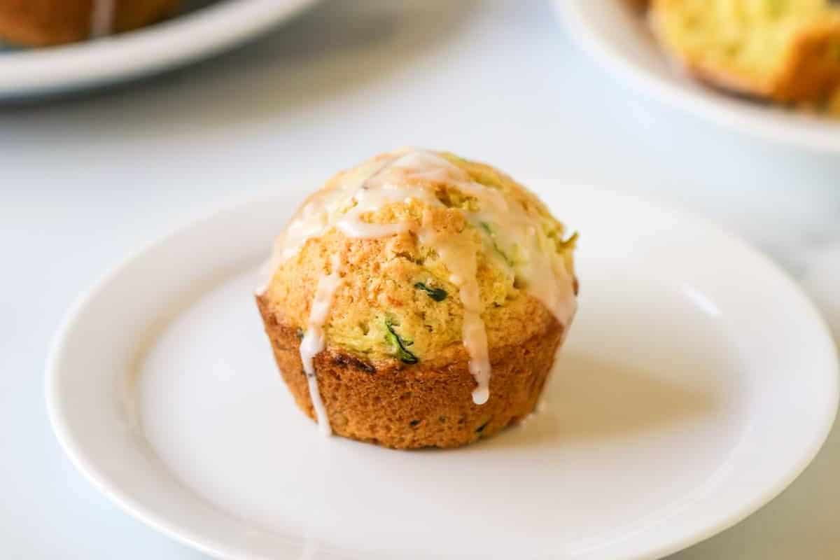 Lemon Zucchini muffin on a ceramic plate.