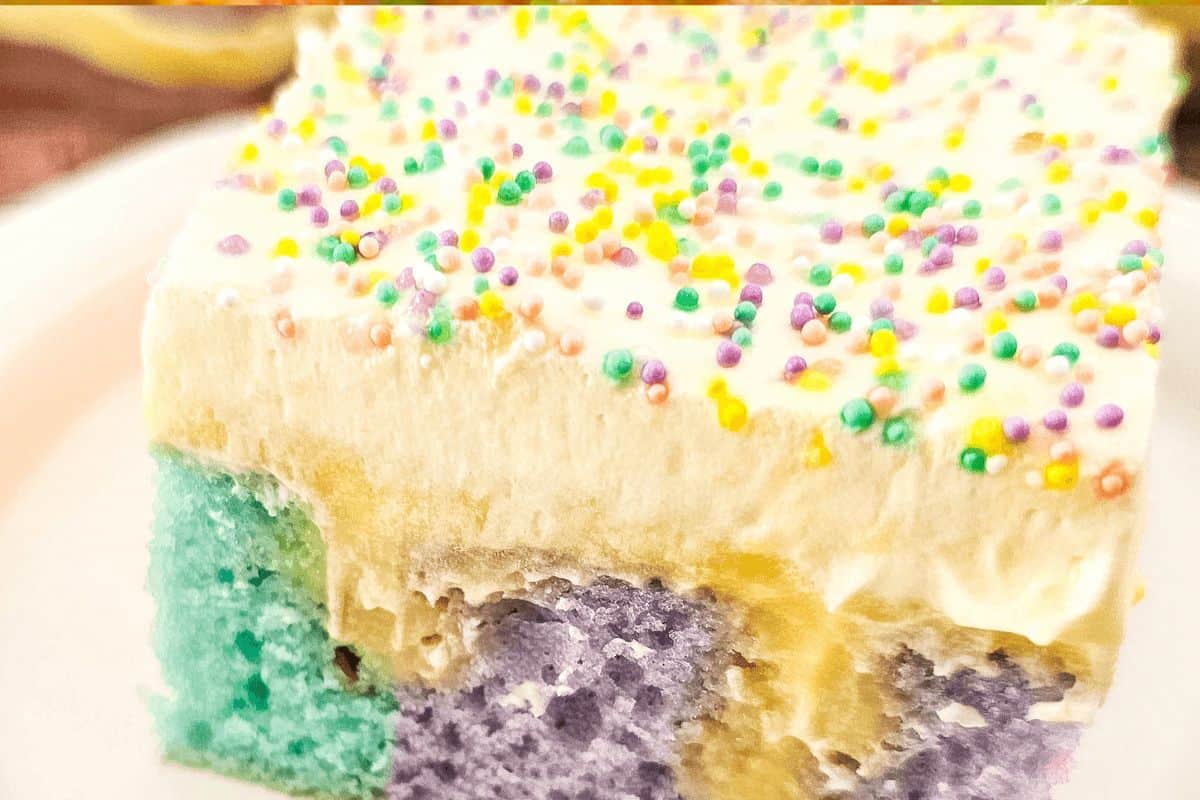 Up-close, vibrant rainbow pudding poke cake. 