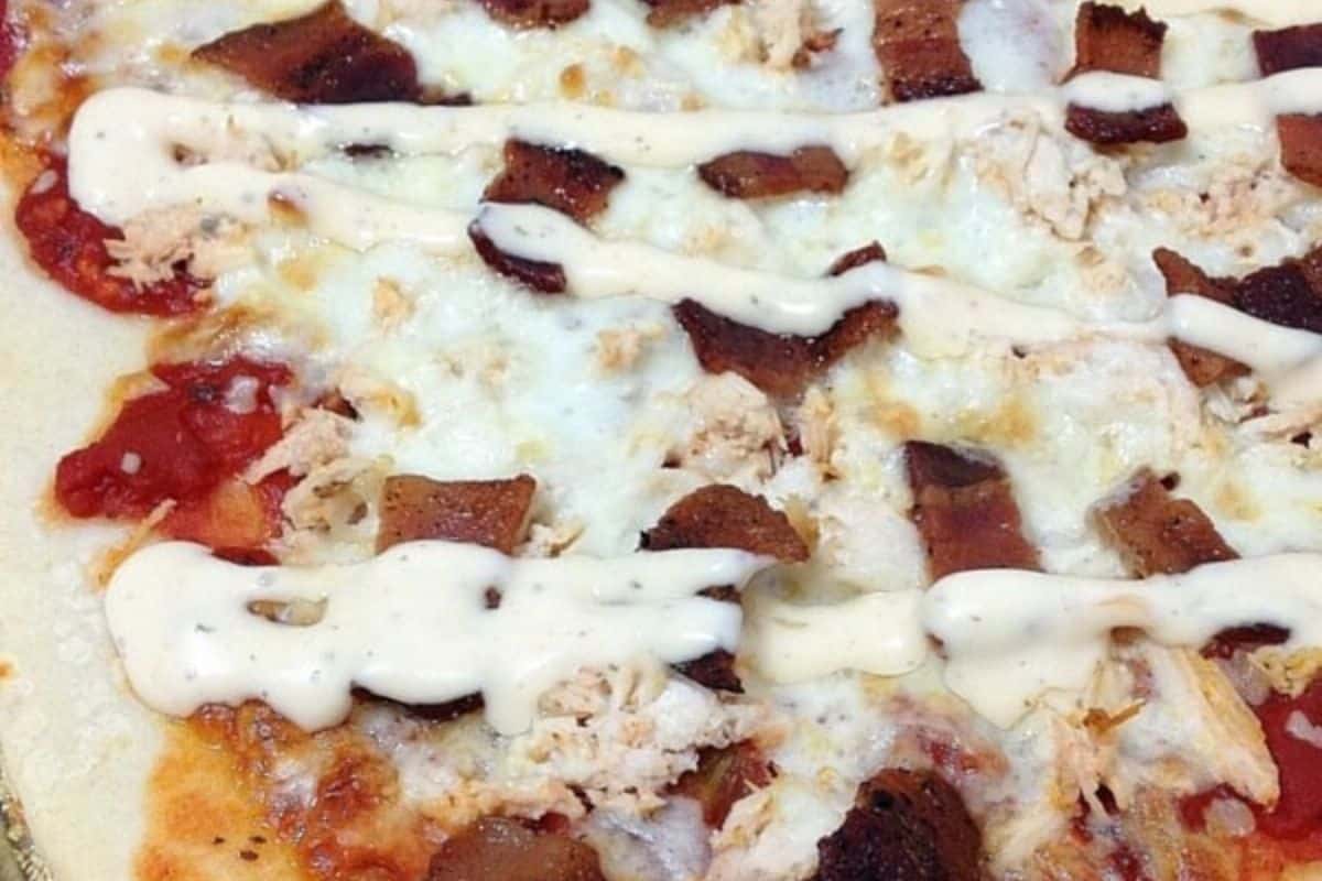 Close-up of homemade bacon ranch pizza. 