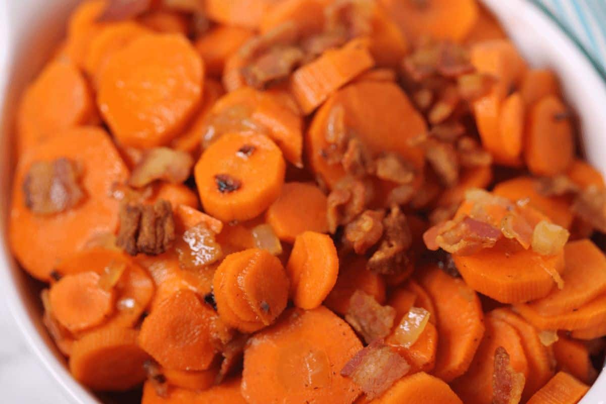 A white bowl of brown sugar bacon carrots.