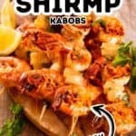 Grilled shrimp kabobs with pineapple and herbs on wooden skewers, served on a wooden board with lemon wedges—these succulent shrimp skewers are perfect for a fresh and flavorful meal.