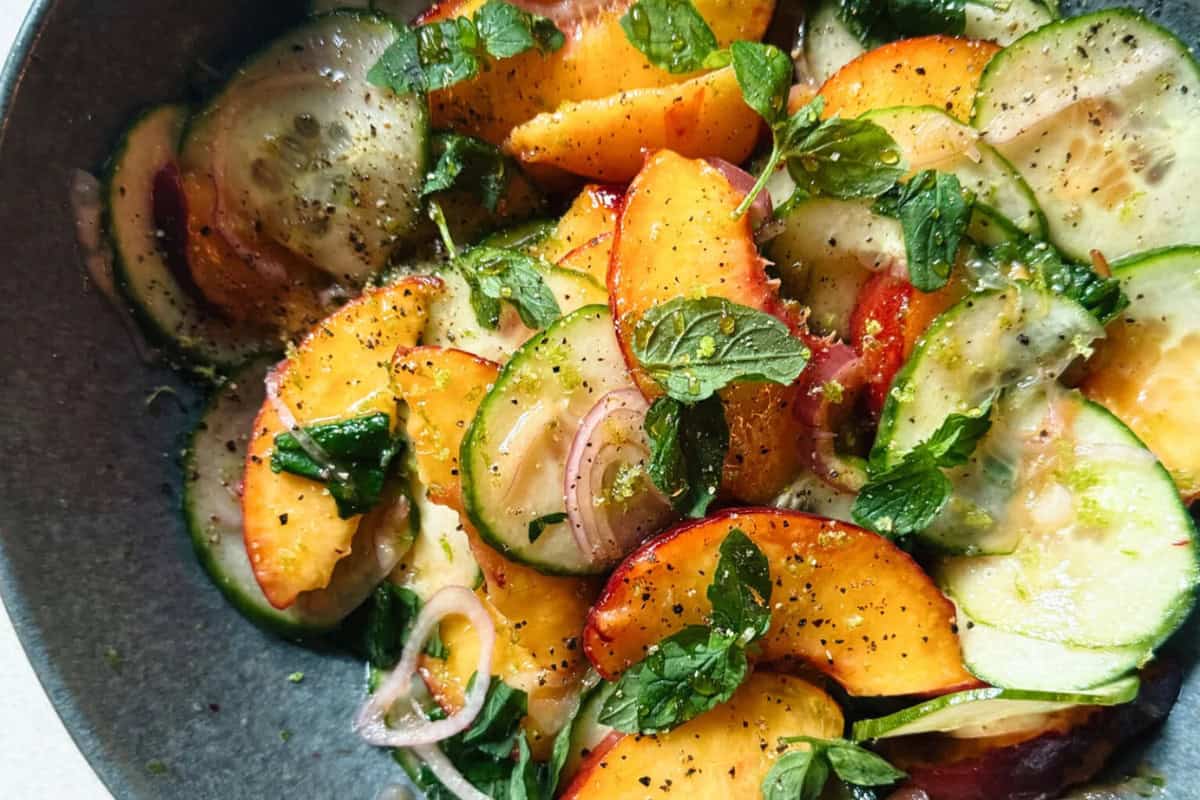 A yummy peach salad filled with greens.