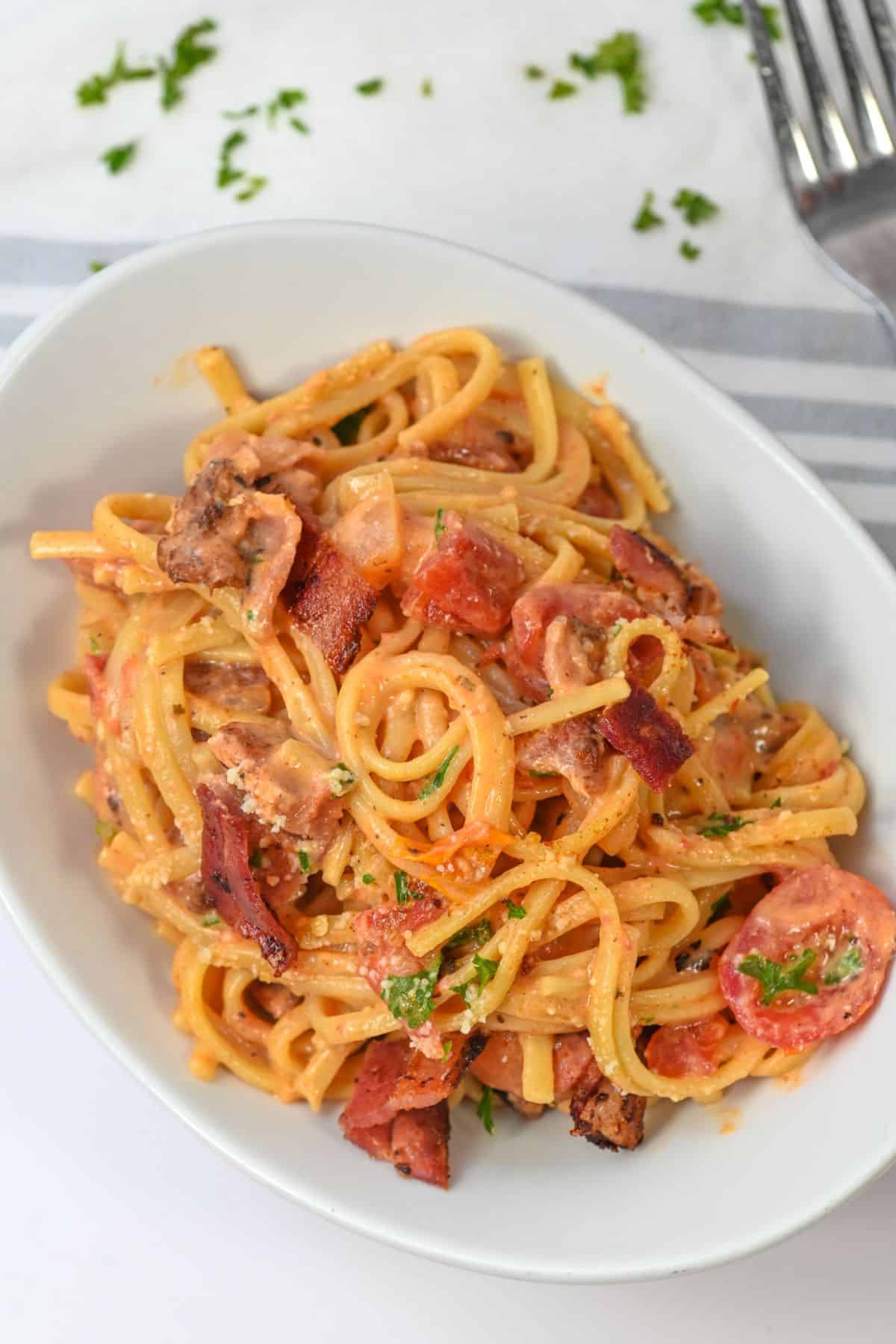 A platter of creamy bacon pasta.