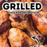 Four grilled chicken drumsticks on a brown plate, with text overlay reading “Marinade for Grilled Chicken Drumstick The Best.” Perfectly juicy and flavorful, these drumsticks showcase the best marinade for grilled chicken drumsticks, ensuring every bite is packed with delicious taste.
