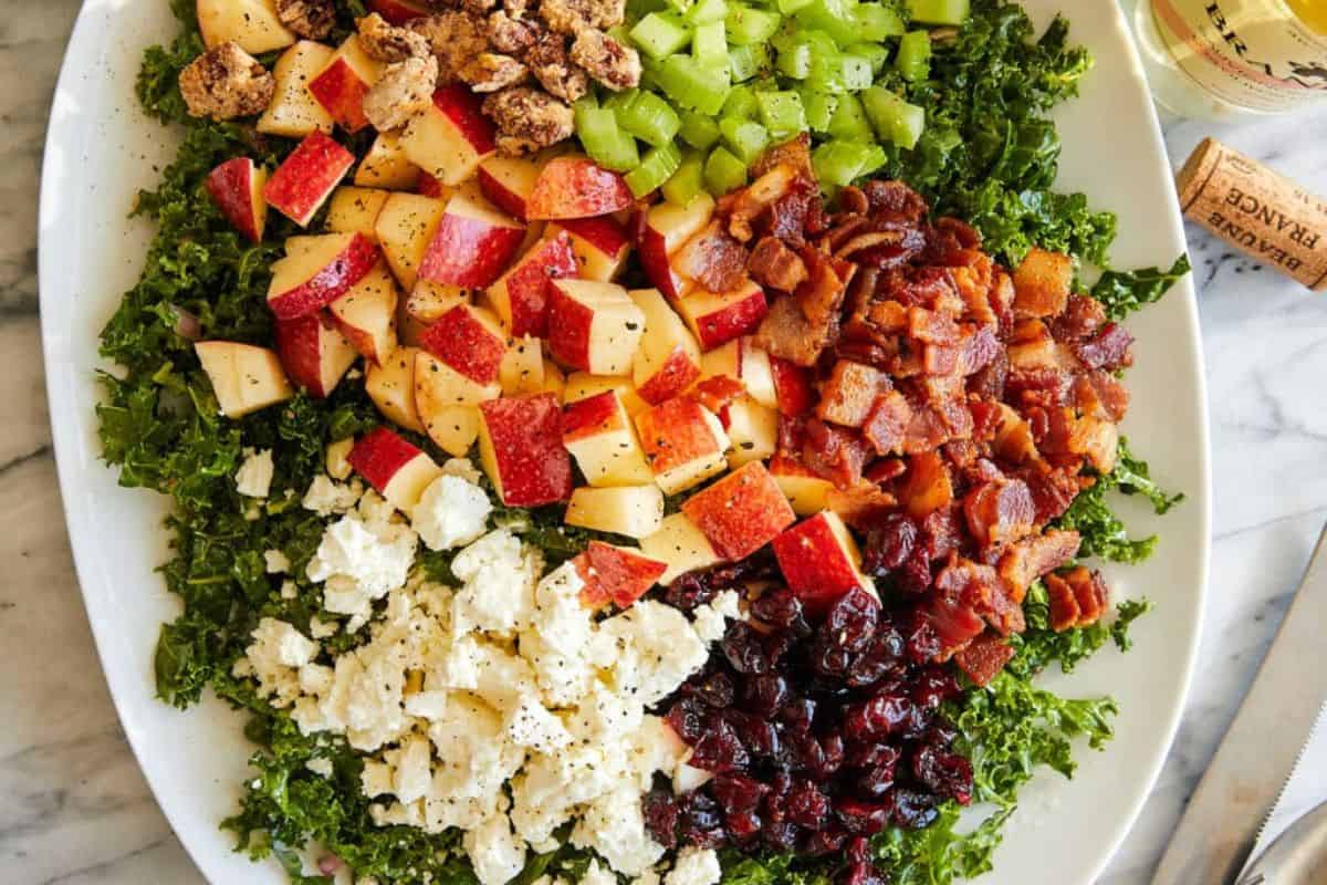 Apple cranberry pecan salad on a white serving dish.