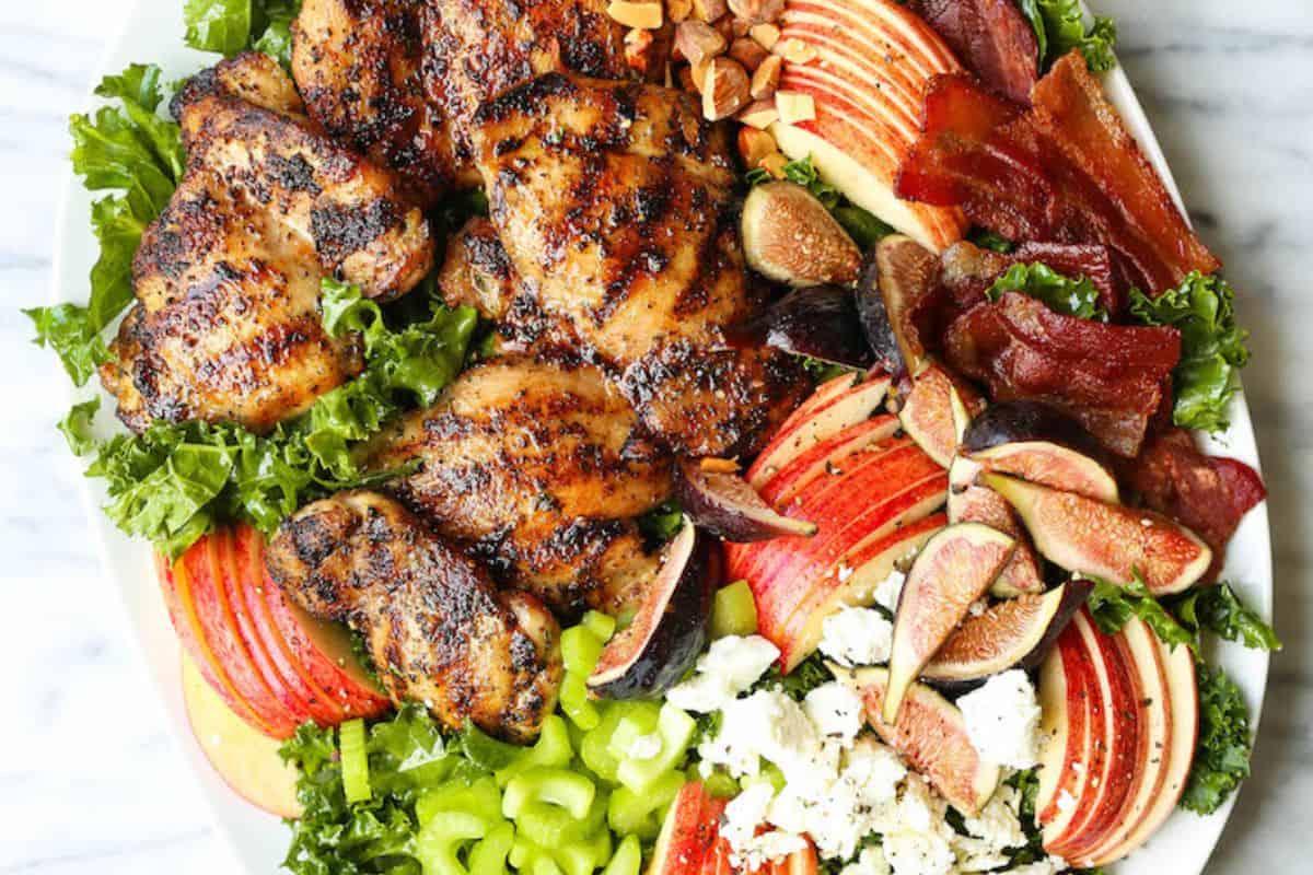 Chicken harvest salad on a white serving dish.