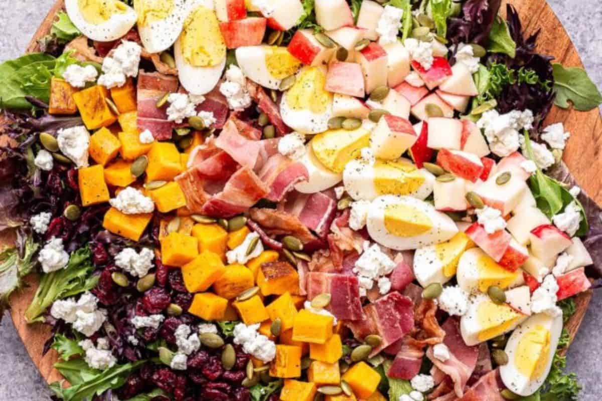 Fall cobb salad on a wooden serving dish.