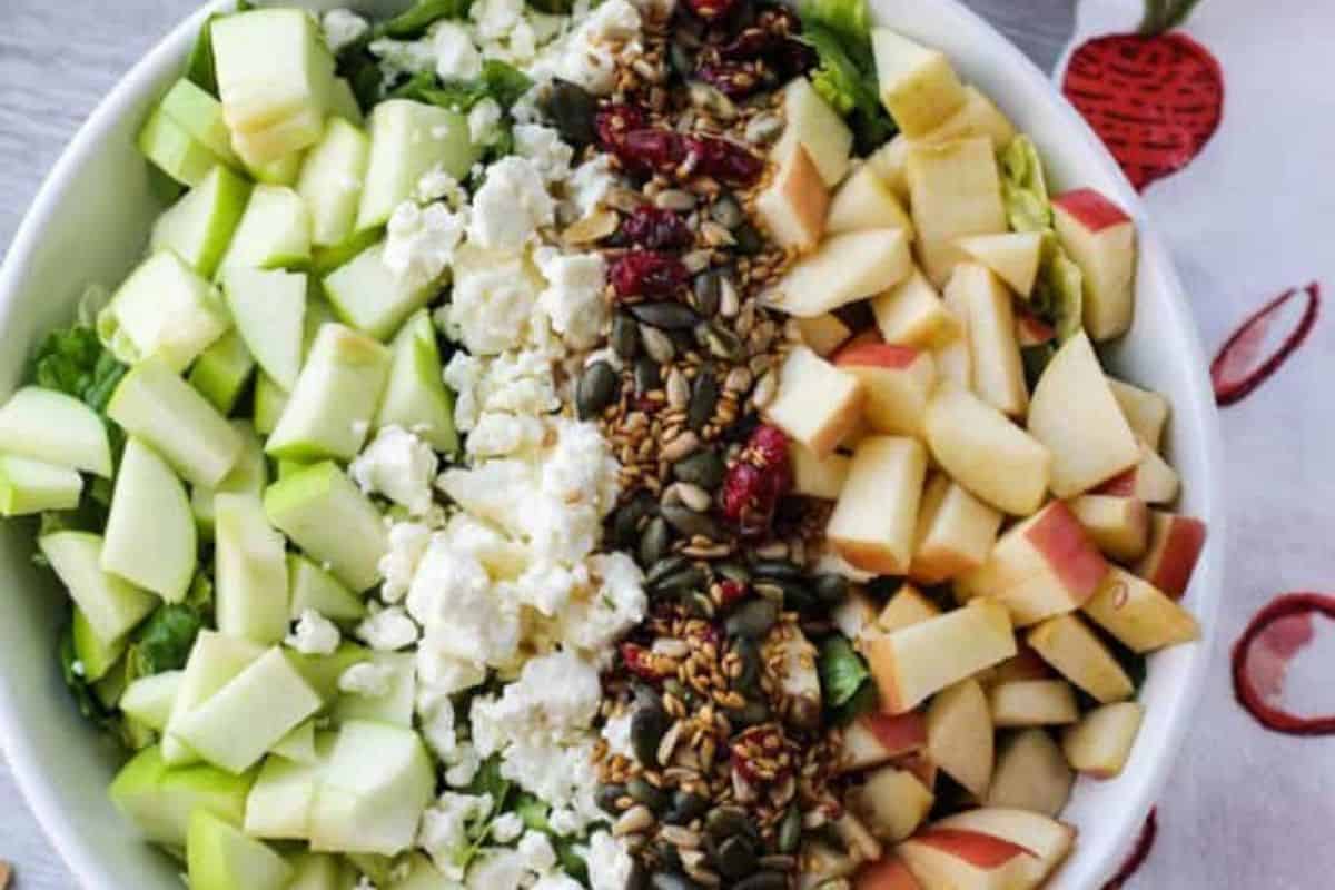 Fall harvest chopped salad in a white bowl.