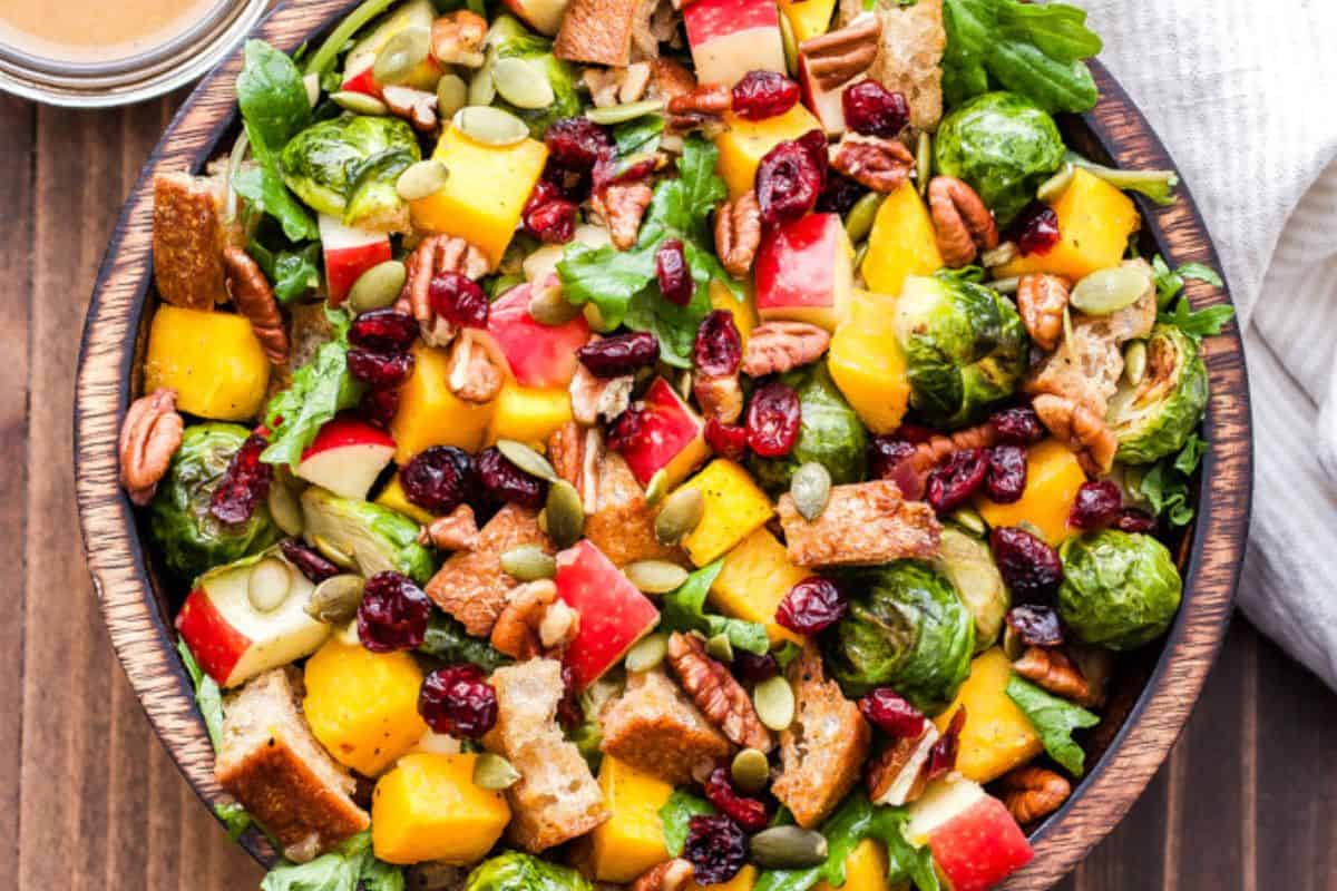 Fall roasted vegetable panzanella salad in a wooden bowl.