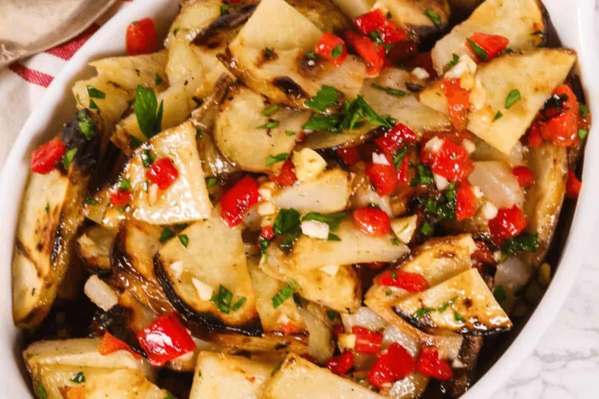 Grilled warm potato salad in a white dish.