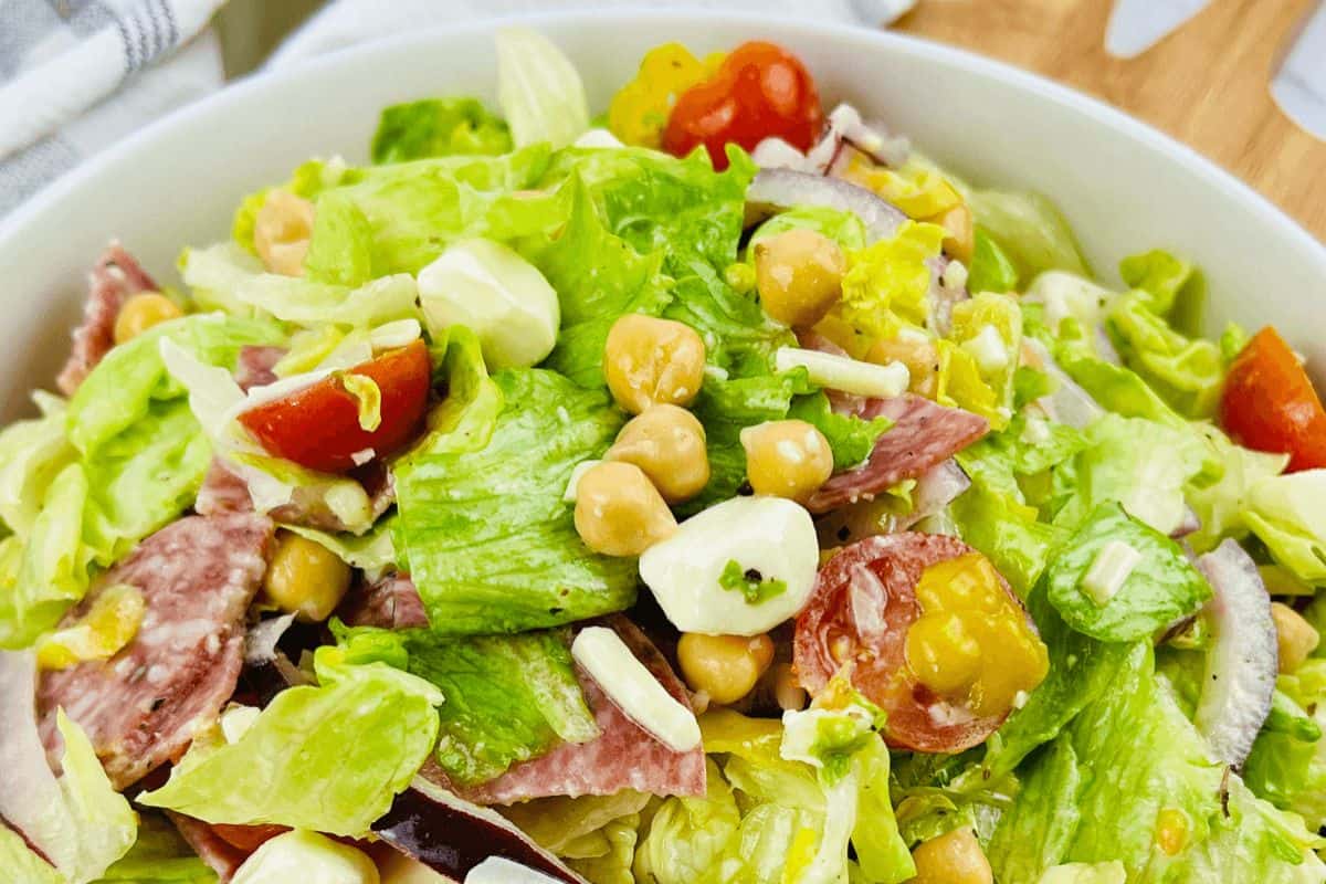 Italian chopped salad in a white dish.