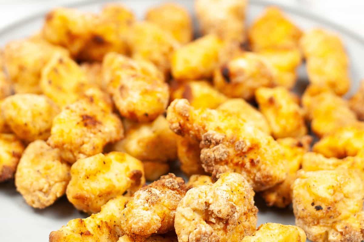 A plate filled with crispy, golden-brown fried chicken pieces reminiscent of Chick-fil-A recipes you can make at home.