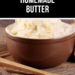 A brown bowl brimming with creamy, homemade butter sits on a wooden surface. Beside it, a wooden spoon holds a small dollop of this rich delight.