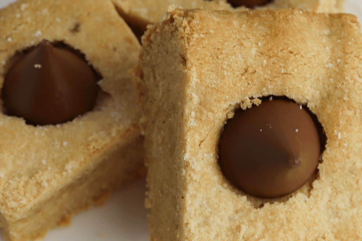 Close-up of square-shaped peanut butter cookies with chocolate Hershey's Kisses in the center, an absolute must-try for any collection of peanut butter recipes.