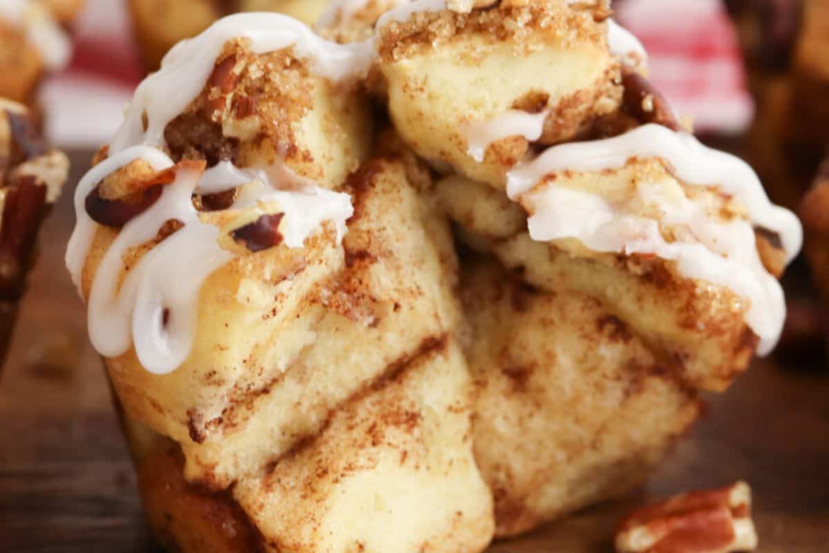 Close-up of cinnamon roll muffin on a wooden surface.