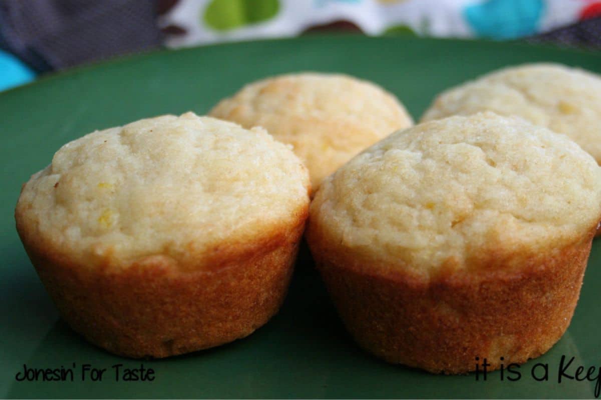 Orange yogurt muffins on a green surface.