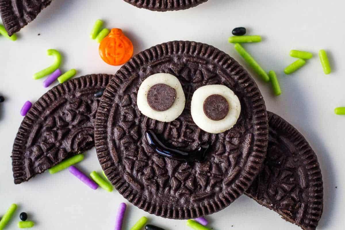 Oreo cookies decorated as bats with black wings attached and small white candy eyes.