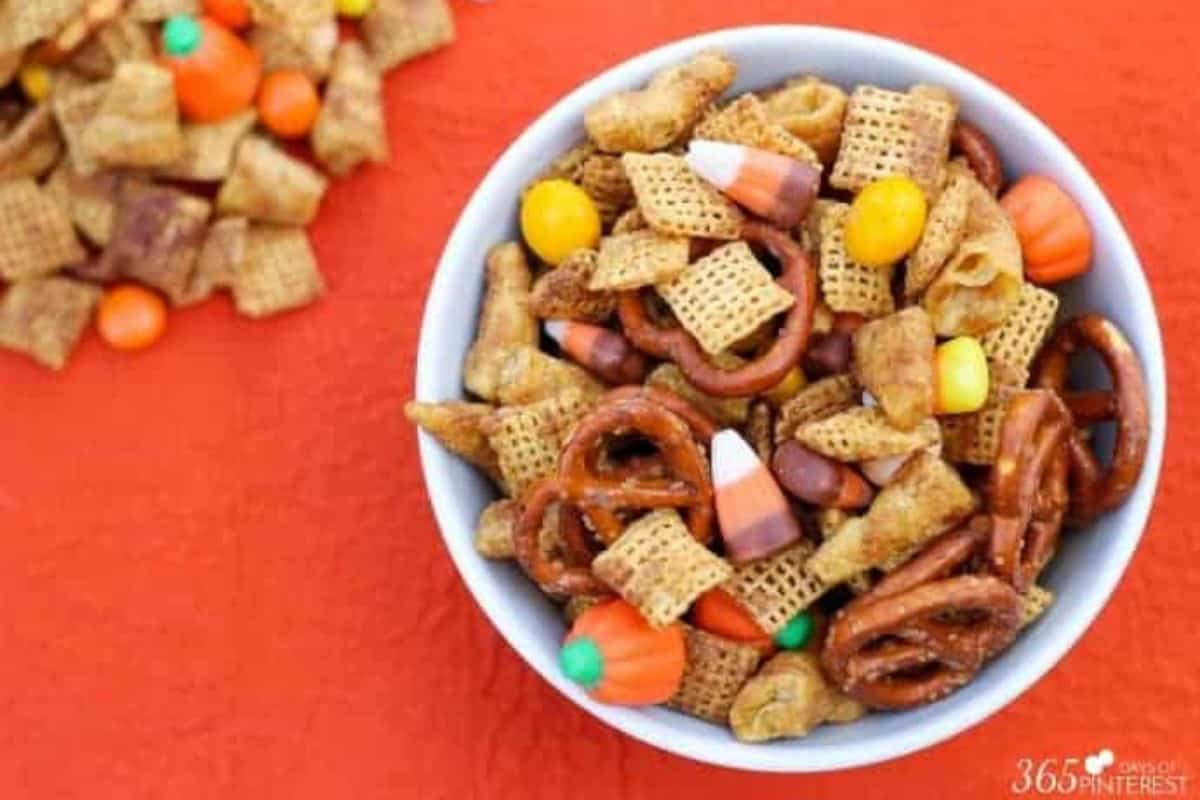 A white bowl of pumpkin spice snack mix.