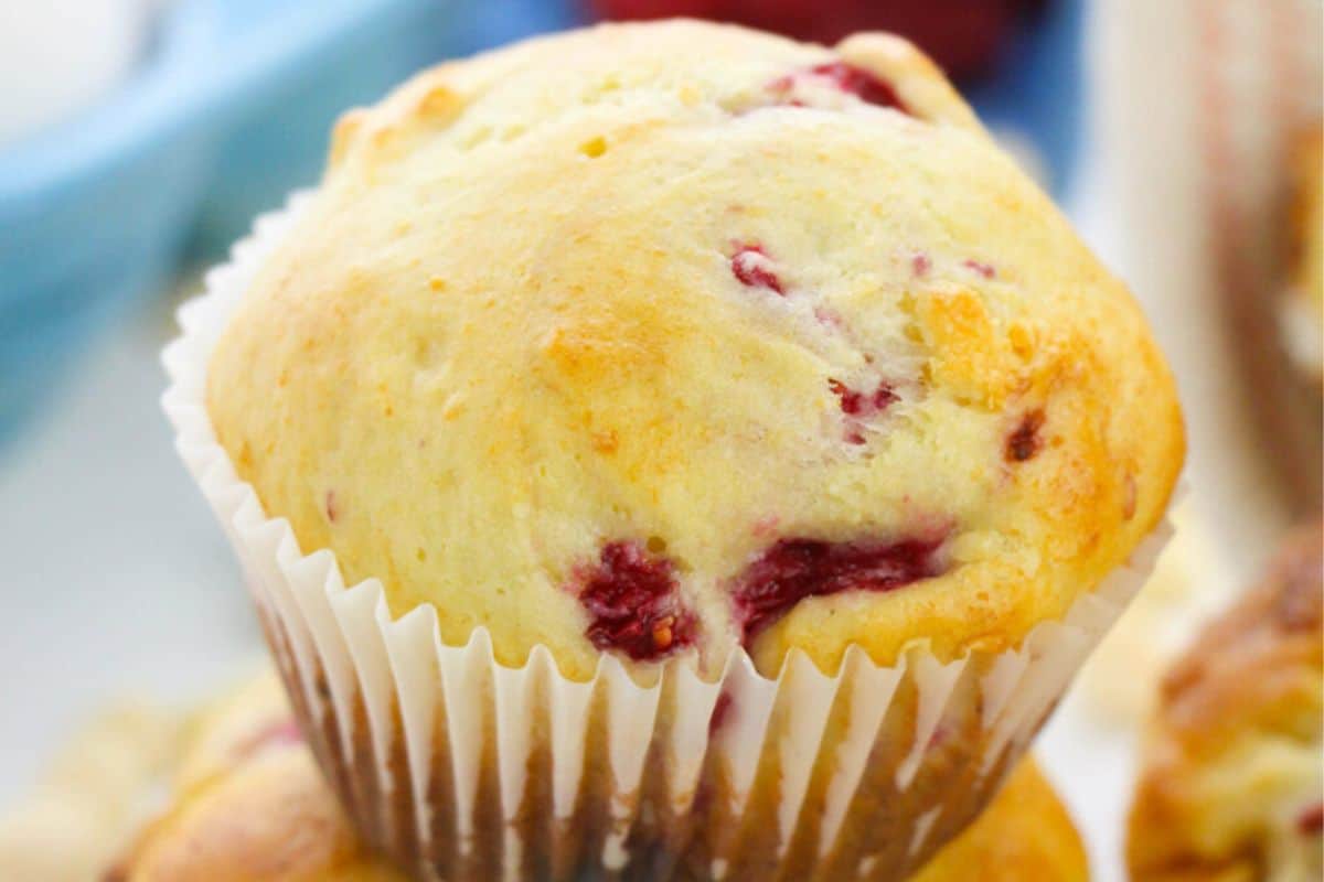 A close-up of a white chocolate and raspberry muffin.