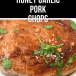 A delectable close-up of honey garlic pork chops beautifully garnished with fresh chopped herbs, elegantly presented on a pristine white plate.