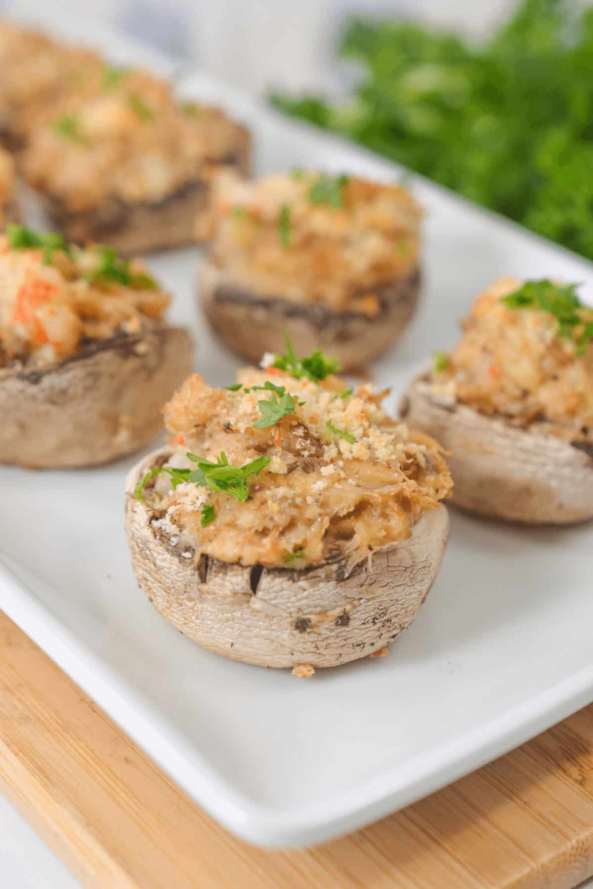 A white plate, perfectly topped with golden breadcrumbs and garnished with fresh parsley.
