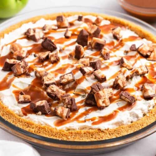 A must try pie with a graham cracker crust, creamy filling, topped with chopped chocolate candy bars and drizzled caramel sauce. Green apples and caramel sauce create the perfect backdrop for this holiday dessert.