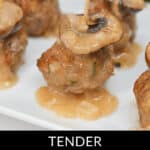 Close-up of veal marsala meatball bites on a white plate, each crowned with a mushroom slice and a toothpick, garnished by greens in the background. Text reads: "Tender Veal Marsala Meatball Bites.