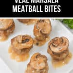 A delectable plate of veal Marsala meatball bites topped with savory mushrooms and rich sauce, elegantly presented on a pristine white dish.