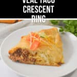 A slice of taco crescent ring sits invitingly on a white plate, garnished with shredded lettuce, juicy tomato, and melted cheese.