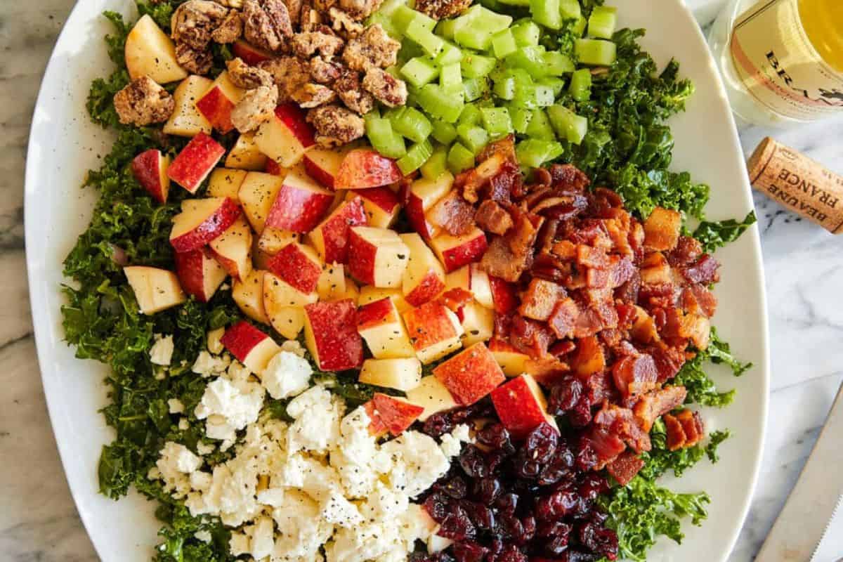 Apple cranberry pecan salad on a white serving dish.