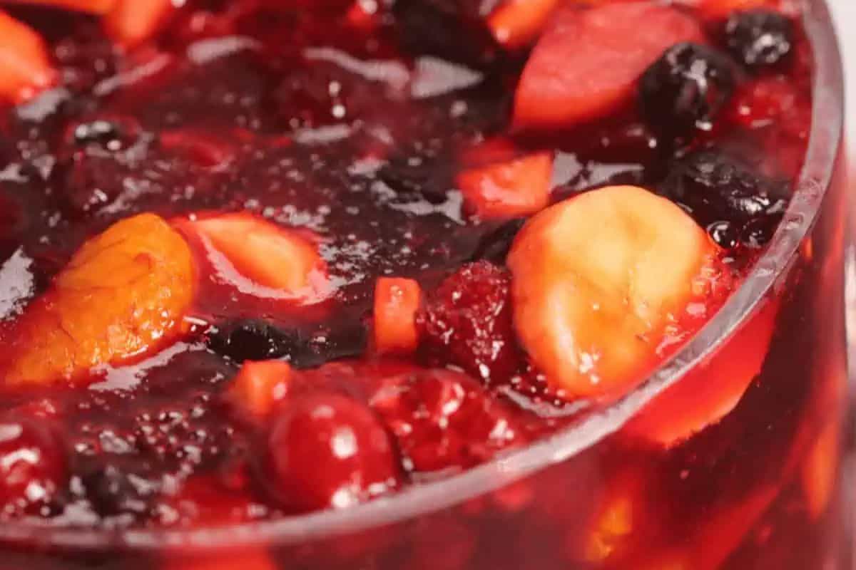 Close-up of cranberry jello salad in a glass container.
