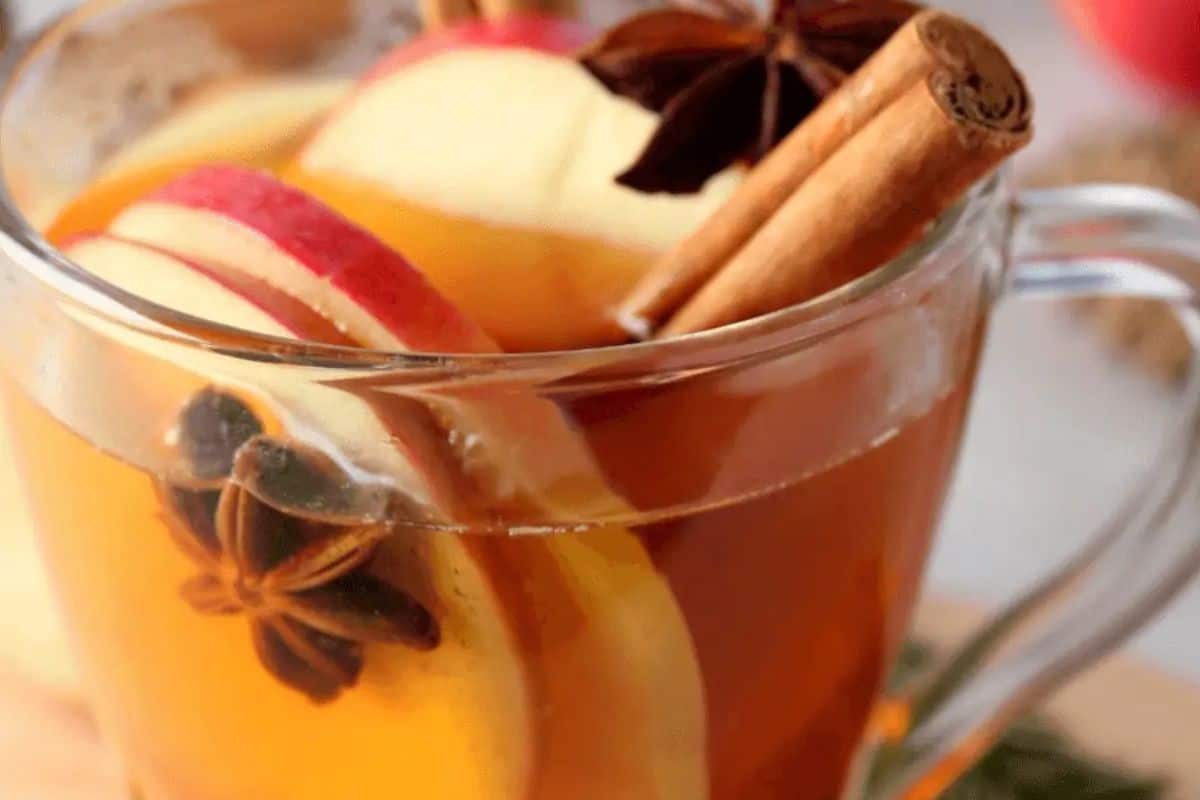 A glass mug of slow cooker cider.