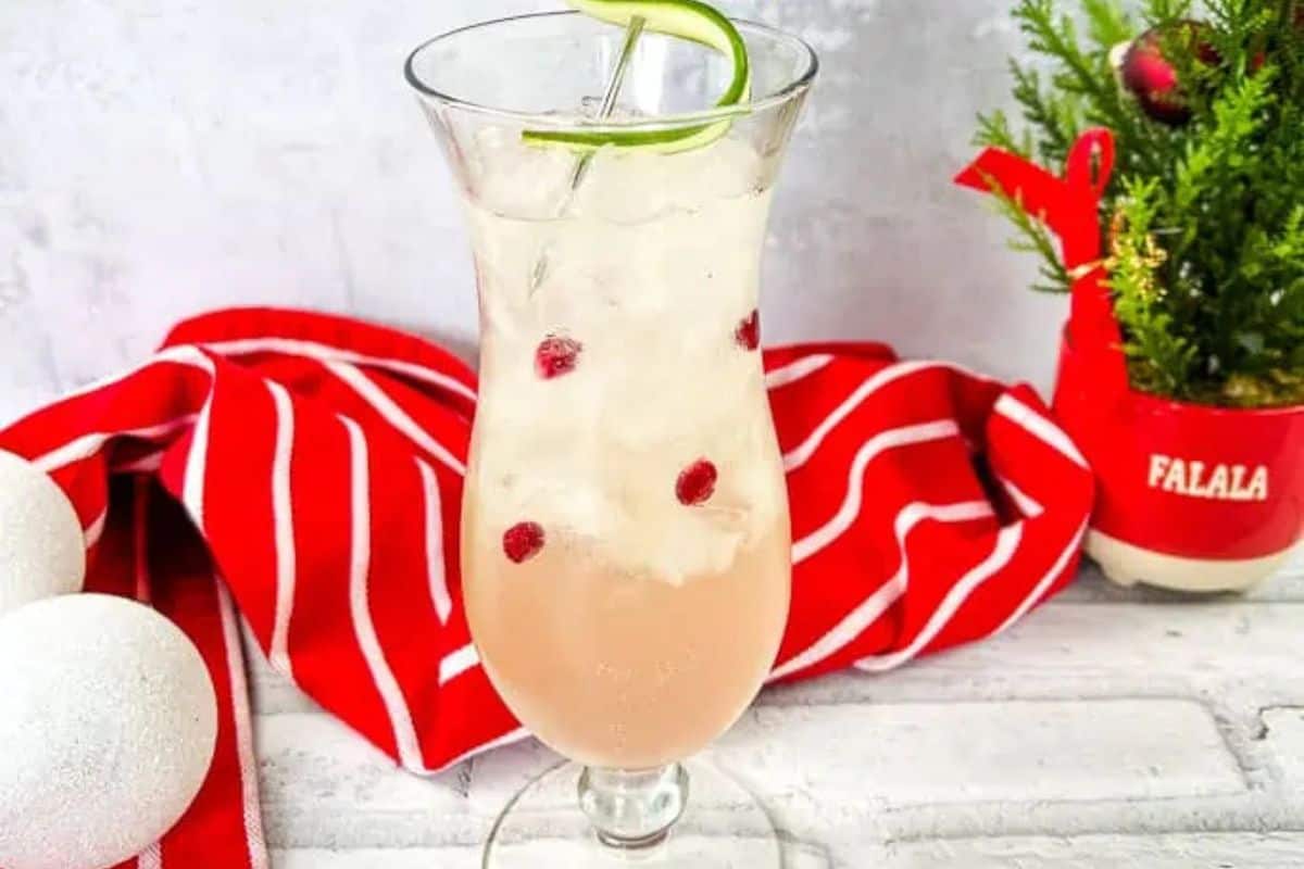 A tall glass of white Christmas cocktail.